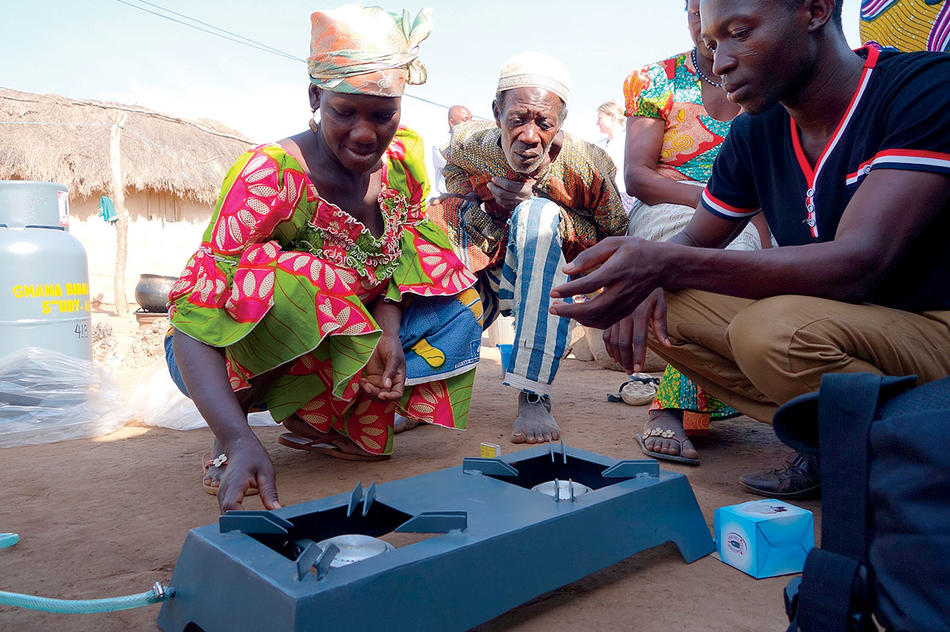 People in Ghana installing a low-emissions stove